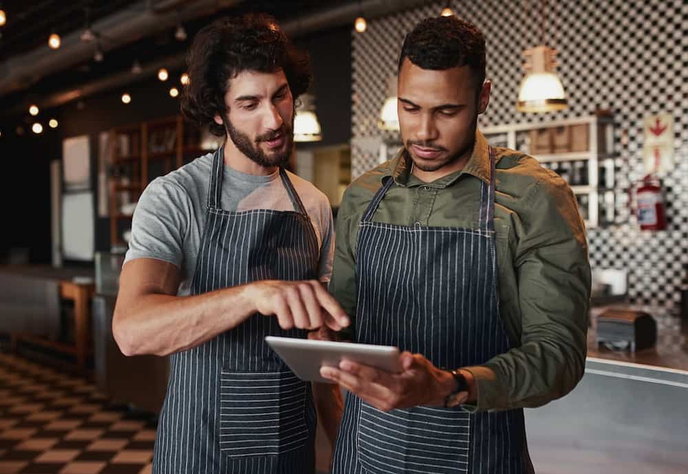 Restaurant employees reviewing sales