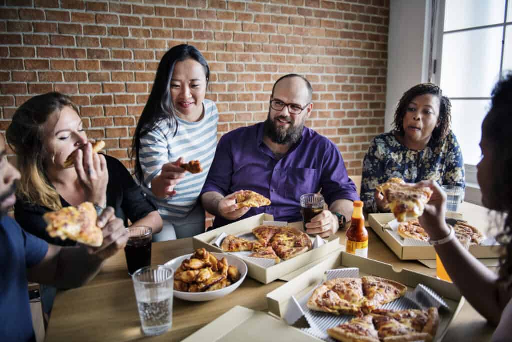 Retail employees enjoying pizza during a break