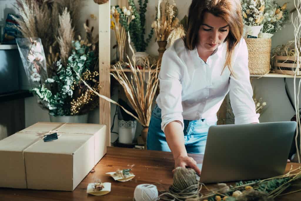 Flower shop owner writing buyer's guide for Mothers' Day