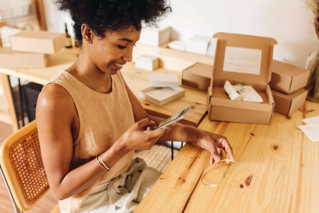 Entrepreneur taking photo of handmade ornament for online selling.