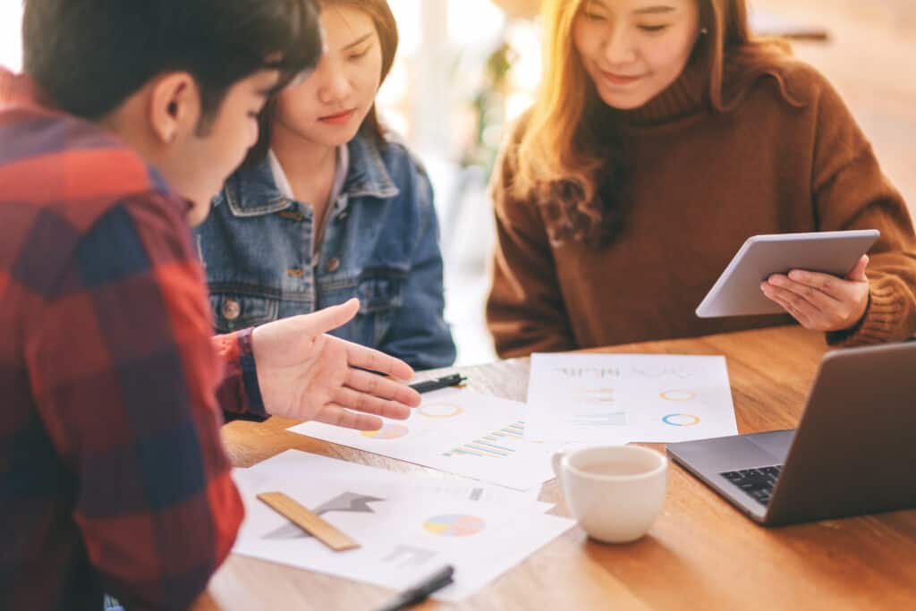 Three asian businessman working and discussing business together in a meeting