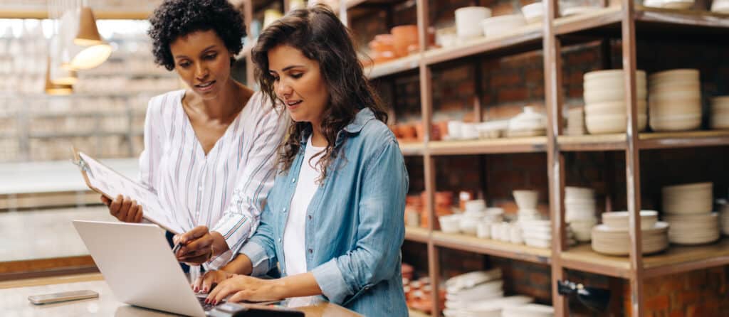 Two businesswomen running a competitor analysis