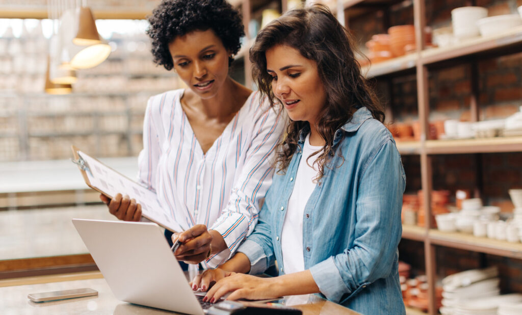 Two businesswomen running a competitor analysis