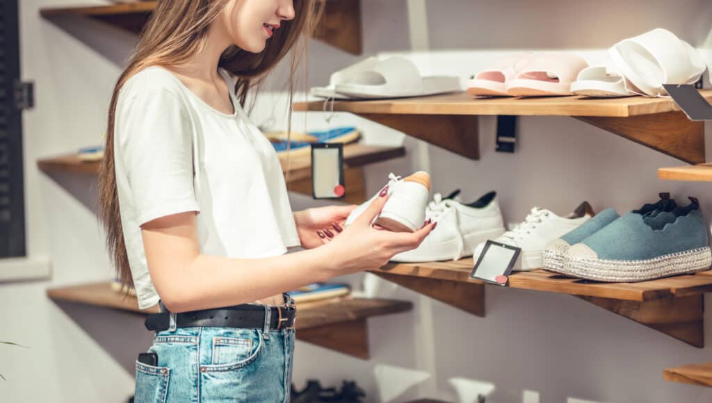 Woman looking at sneakers in a showroom